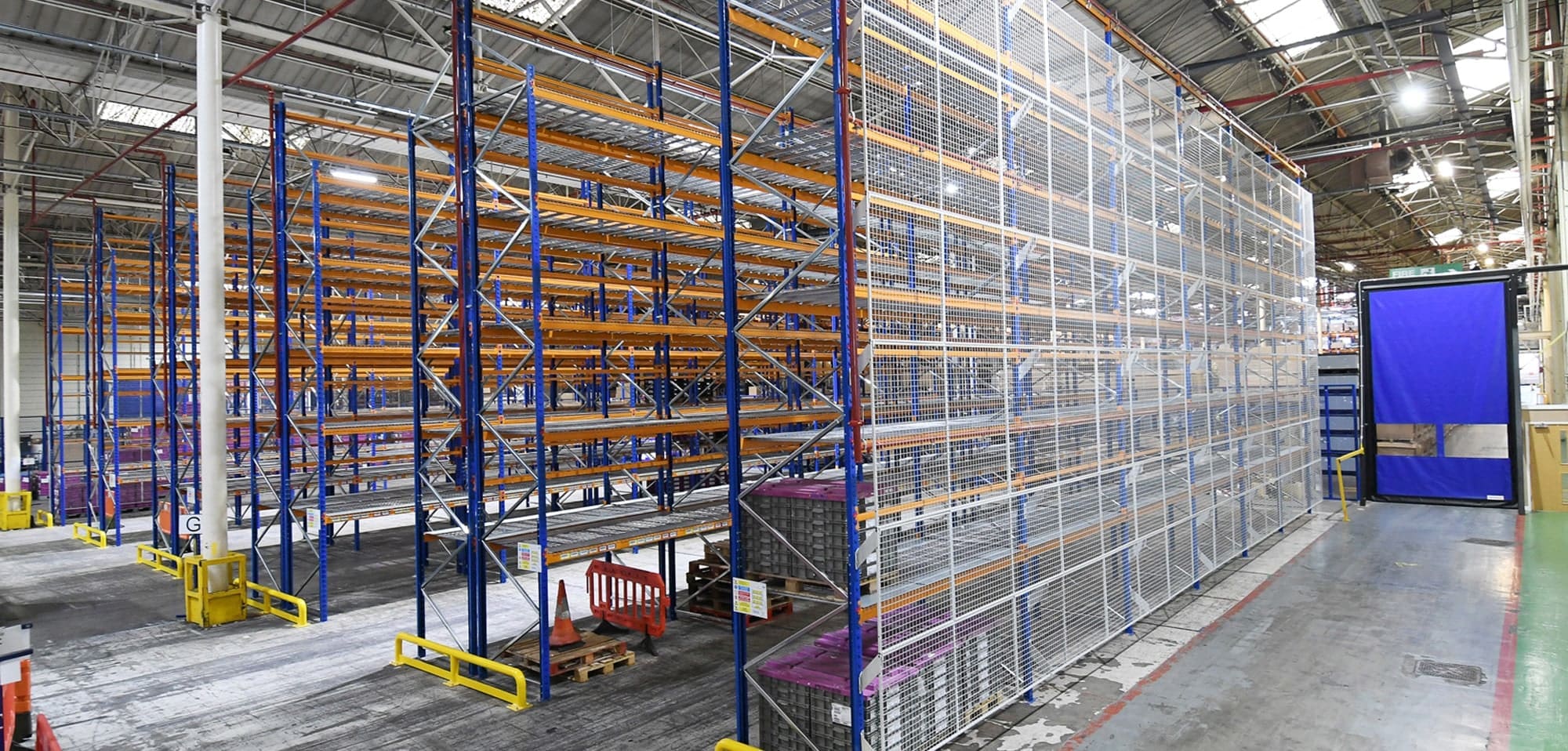 a warehouse with racking designed to meet pallet racking safety guidelines
